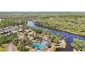 Stunning aerial view of community with a pool and river, surrounded by lush greenery and peaceful scenery at 1111 W Faith Cir # 2004, Bradenton, FL 34212