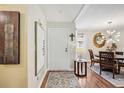 Inviting entryway with hardwood floors leading to a dining area, decorated with modern accents at 1111 W Faith Cir # 2004, Bradenton, FL 34212