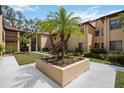 Condo exterior showcasing a well-maintained lawn, mature landscaping, and inviting architectural details at 1111 W Faith Cir # 2004, Bradenton, FL 34212
