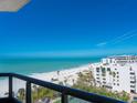 Expansive beach view from a private balcony, ideal for enjoying the serene coastal scenery at 1281 Gulf Of Mexico Dr # 704, Longboat Key, FL 34228