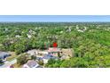 Aerial view of a single-story home nestled among green trees and other homes in a lush community at 15107 3Rd E Dr, Bradenton, FL 34212