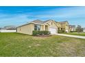 View of a single Gathering home featuring lush green grass and neat landscaping at 15207 Peaceful Bull Pl, Bradenton, FL 34212
