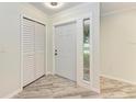 Inviting entryway featuring a large front door, tile floors, and a coat closet at 2601 13Th W St, Palmetto, FL 34221