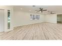 Bright living room with lots of space and a neutral color scheme, ceiling fans, and recessed lighting at 2601 13Th W St, Palmetto, FL 34221