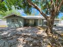 Charming single-story home with mature trees providing shade, well-kept landscaping, and inviting curb appeal at 2727 Waldemere St, Sarasota, FL 34239