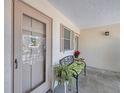The front door is shown with charming bench seating and greenery at 2839 Swifton Dr # 28, Sarasota, FL 34231