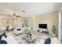 Bright living room with a ceiling fan, neutral walls, and large windows bringing in lots of natural light at 2839 Swifton Dr # 28, Sarasota, FL 34231