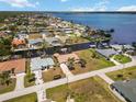 This aerial view shows single Gathering homes along canals with easy access to the open water at 3069 Stone St, Port Charlotte, FL 33981