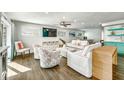 Bright living room boasts hardwood floors, comfy seating, and a TV for cozy entertainment at 336 Avenida De Mayo, Sarasota, FL 34242