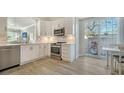 Modern kitchen with stainless steel appliances, white cabinets, and a breakfast area with a sliding door at 3424 Hadfield Greene # 17, Sarasota, FL 34235