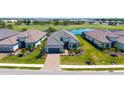 Charming single-story home showcasing lush landscaping, a paver driveway and a two-car garage at 3568 Santa Caterina Blvd, Bradenton, FL 34211
