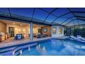 A gorgeous in-ground pool sits next to an outdoor seating area at 3568 Santa Caterina Blvd, Bradenton, FL 34211