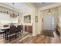 Open dining room boasts decorative furnishings, artwork, modern chandelier, and wood-look flooring at 3752 Summerwind Cir, Bradenton, FL 34209