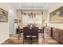 Bright dining room features wood-look floors, modern furnishings, art, and a view of the window at 3752 Summerwind Cir, Bradenton, FL 34209