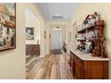Inviting foyer features wood-look floors, antique furnishings, decorative art and a view of the front door at 3752 Summerwind Cir, Bradenton, FL 34209