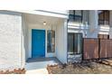 Inviting front entrance with a blue door, natural lighting, and a quaint outdoor patio area at 4001 Beneva Rd # 343, Sarasota, FL 34233