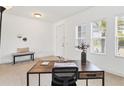 Bright office space with a work desk, bench, natural light from large windows, and neutral decor at 4107 Pine Meadow Dr, Parrish, FL 34219