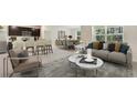 Open-concept living area with neutral tones, stylish furniture, and a seamless flow to the dining and kitchen at 4108 112Th E St, Palmetto, FL 34221