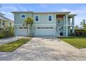 Charming two-story home with a two-car garage, brick driveway, and a private entrance staircase at 4109 Cobia Ct, Palmetto, FL 34221