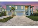 Charming two-story home with a two-car garage, brick driveway, and a private entrance staircase at 4109 Cobia Ct, Palmetto, FL 34221