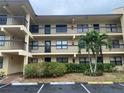 Exterior of the building showing multiple units with balconies and well-maintained landscaping at 425 30Th W Ave # C112, Bradenton, FL 34205