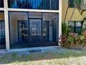 Screened patio area, offering a relaxing outdoor space with lush tropical plants, and unit D, perfect for enjoying fresh air at 425 30Th W Ave # C112, Bradenton, FL 34205