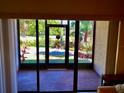 View from the screened patio, featuring a serene pond and lush tropical landscaping, creating a tranquil outdoor retreat at 425 30Th W Ave # C112, Bradenton, FL 34205