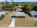 An aerial view of a single-story home with an adjacent carport in a residential neighborhood at 425 Skylark Nw Ln, Port Charlotte, FL 33952