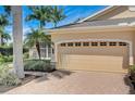 Well-maintained three car garage showing paver driveway and meticulous landscaping for a warm and inviting exterior at 4250 Turnberry Cir, North Port, FL 34288