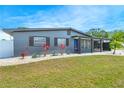 Well-maintained single-story home with a manicured lawn, rock landscaping and modern architectural design elements at 4409 Maceachen Blvd, Sarasota, FL 34233