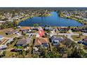 Aerial view of a single-Gathering home near a lake, featuring a private pool and well-maintained landscaping at 4655 Payne St, North Port, FL 34287