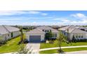 Stunning aerial view of a home featuring a tile roof, paver driveway, and well-kept landscaping at 4711 Cedron Ct, Sarasota, FL 34240