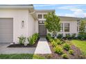 Inviting front entry with a stone walkway, lush landscaping, and modern lighting fixtures at 4711 Cedron Ct, Sarasota, FL 34240
