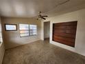 Bright living room featuring large windows, a ceiling fan, and a unique built-in wooden shelf at 4712 Cronin Dr, Sarasota, FL 34232