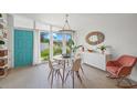 Bright dining area with modern light fixture, and a large window overlooking the well-manicured front yard at 4801 Sarasota Ave, Sarasota, FL 34234
