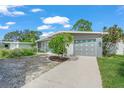 Lovely exterior view showing the garage with eye-catching blue diamond accents and lush landscaping at 4801 Sarasota Ave, Sarasota, FL 34234