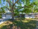 Charming single-story home with a well-manicured lawn and mature tree offering plenty of shade at 4806 Capri Ave, Sarasota, FL 34235