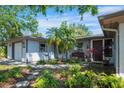 Inviting single-story home with a lovely garden and walkway leading to the front door at 4806 Capri Ave, Sarasota, FL 34235