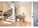 Bright foyer featuring a staircase with wrought iron details, wood flooring and neutral decor at 5607 78Th E Ave, Palmetto, FL 34221