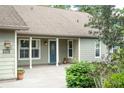 Inviting front entrance with a blue door, covered porch, and tasteful landscaping, offering a warm welcome at 5607 78Th E Ave, Palmetto, FL 34221