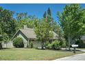 Charming single-story home featuring a well-manicured lawn and lush landscaping, creating a serene curb appeal at 5607 78Th E Ave, Palmetto, FL 34221