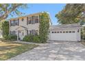 Two-story home featuring well-maintained landscaping and an attached two-car garage at 5766 Forester Pine Ct, Sarasota, FL 34243