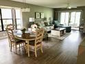 Comfortable open floor plan with hardwood floors, sofa, love seat, chairs, and outdoor patio at 5767 Avista Dr # 5767, Sarasota, FL 34243