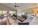 Inviting living room featuring wood floors, a ceiling fan, and access to a porch at 612 Fern St, Anna Maria, FL 34216
