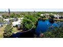 Scenic aerial view of the property showcasing its proximity to a beautiful lake with a fountain and lush landscaping at 631 Woodlawn Dr, Bradenton, FL 34210