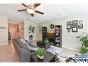 Open living area with tile flooring, comfortable seating, and access to other parts of the home at 6723 Trent Creek Dr, Sun City Center, FL 33573