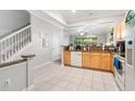 Bright kitchen featuring tile floors, granite countertops, stainless steel appliances, and ample cabinet space at 7180 83Rd E Dr # 6-5, Bradenton, FL 34201