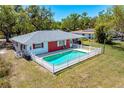 A lovely backyard with a refreshing in-ground pool and a white picket fence, perfect for outdoor enjoyment at 7299 S Leewynn Dr, Sarasota, FL 34240