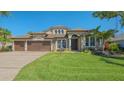 Beautiful single-Gathering home featuring a manicured lawn and a three-car garage at 7407 Green St, Bradenton, FL 34201