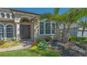 Close-up of front door with beautiful landscaping and a paver walkway at 7407 Green St, Bradenton, FL 34201
